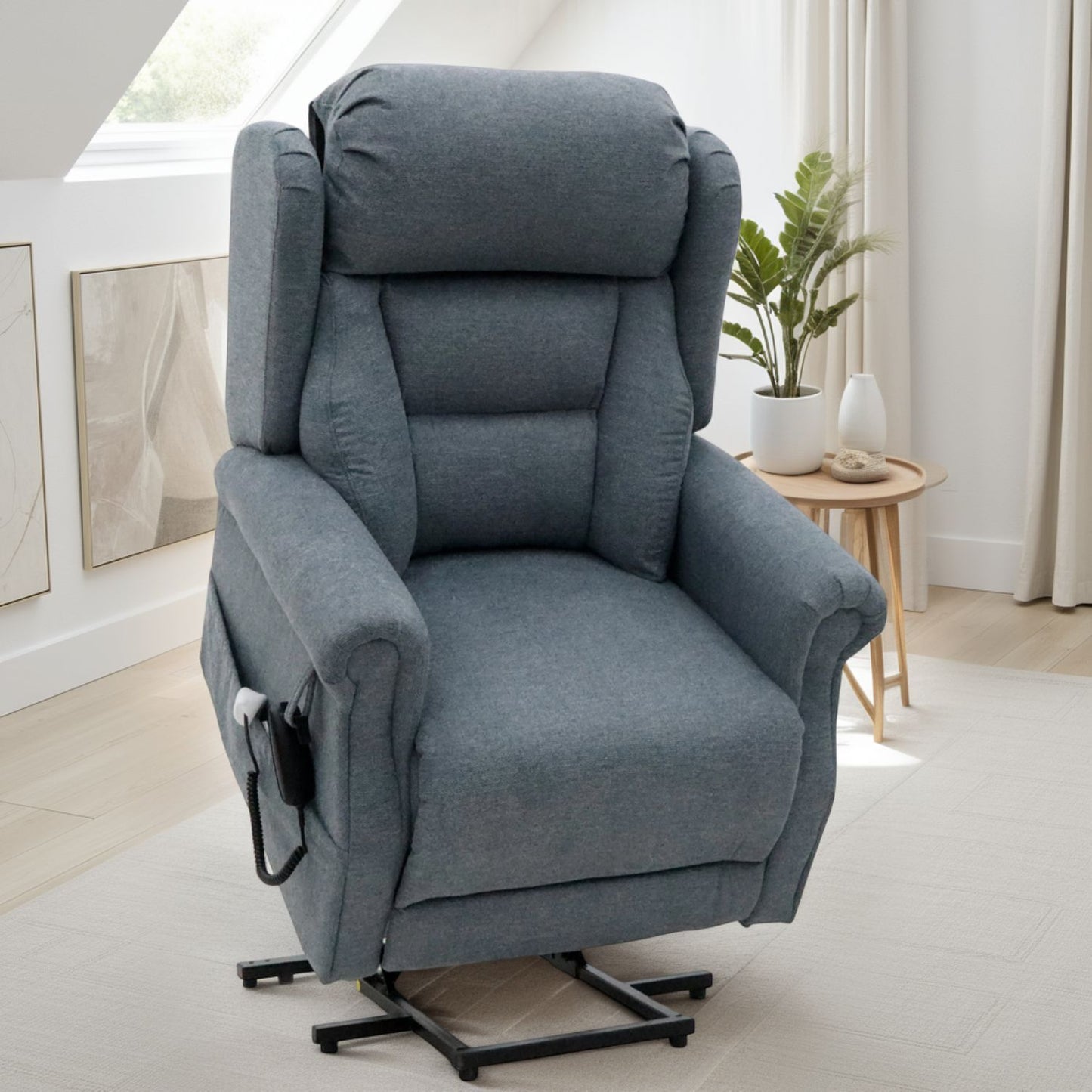 Gray recliner chair in a room with a small table and plant